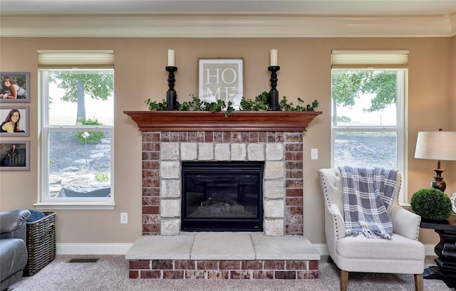 living room with ornamental molding, a healthy amount of sunlight, and carpet flooring