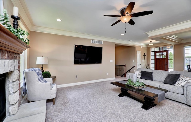 living room with crown molding, carpet flooring, and a fireplace