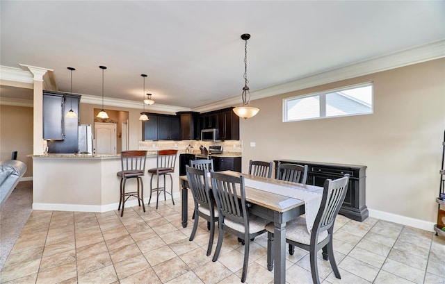 dining space with crown molding and light tile patterned flooring