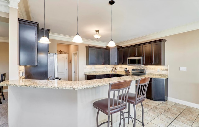 kitchen with crown molding, stainless steel appliances, decorative light fixtures, and light stone countertops