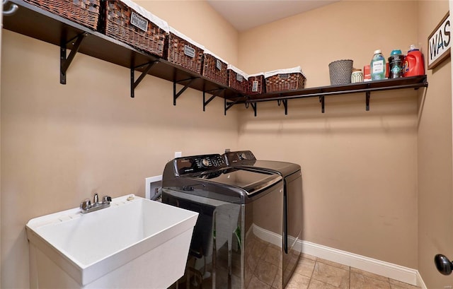 washroom with sink and washer and clothes dryer