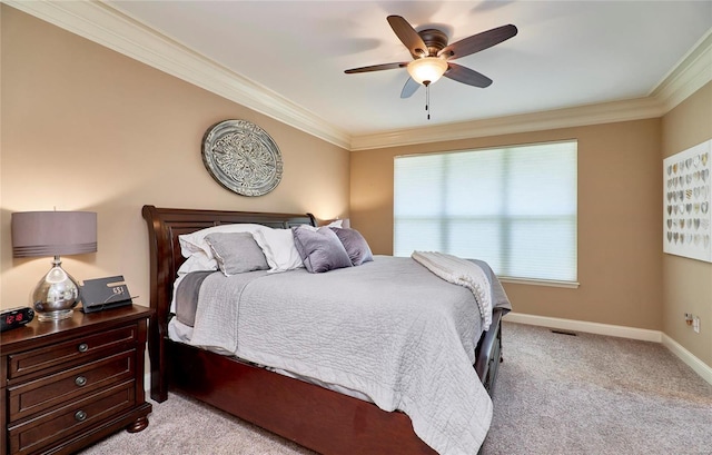 bedroom featuring ornamental molding, light colored carpet, and ceiling fan