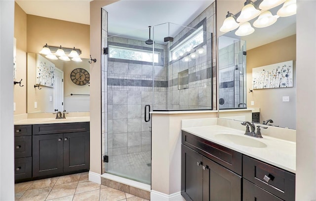 bathroom featuring tile patterned flooring, vanity, and walk in shower