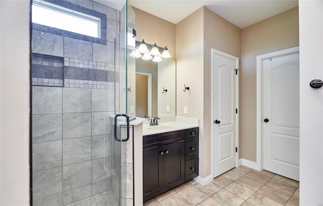 bathroom featuring a shower with door, vanity, and tile patterned floors