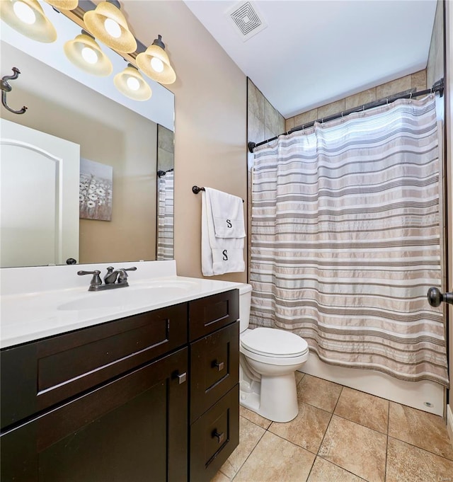 bathroom featuring vanity, toilet, and tile patterned flooring