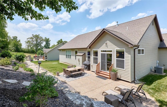 rear view of house featuring a yard, central AC, and a patio area