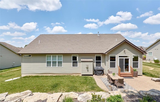 rear view of house featuring a patio area and a lawn