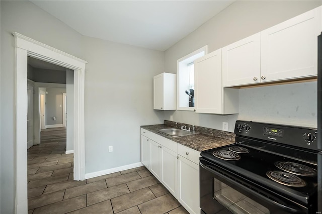 kitchen with black / electric stove, white cabinetry, and sink