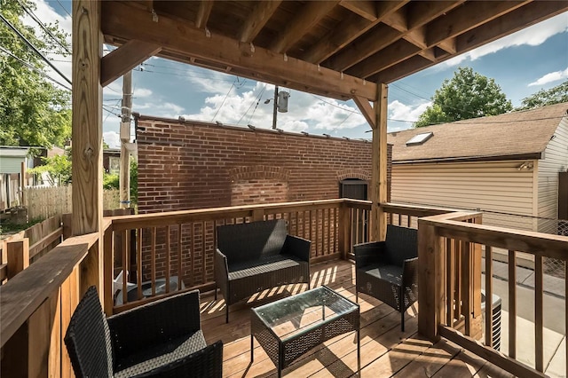 wooden terrace with an outdoor living space