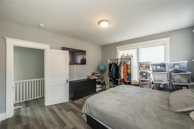 bedroom with dark wood-type flooring