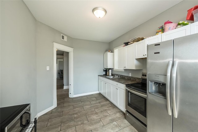 kitchen featuring white cabinetry, sink, and appliances with stainless steel finishes