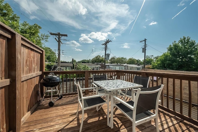 wooden deck featuring a grill