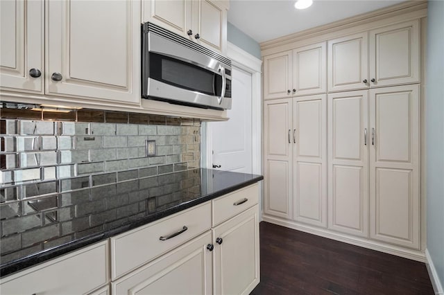 kitchen featuring dark hardwood / wood-style floors and backsplash