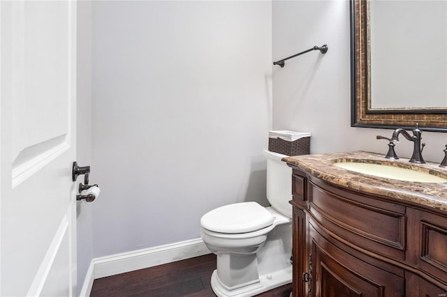 bathroom featuring hardwood / wood-style flooring, vanity, and toilet