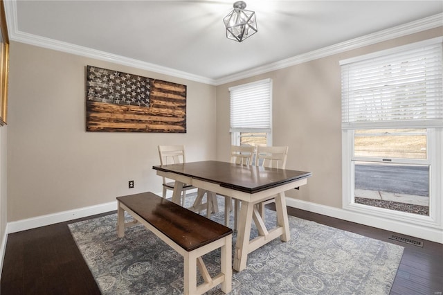 dining room featuring ornamental molding and dark hardwood / wood-style floors