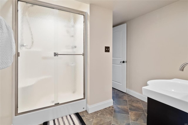 bathroom featuring vanity and a shower with door