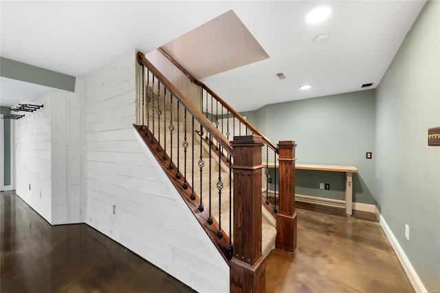 stairs with concrete flooring