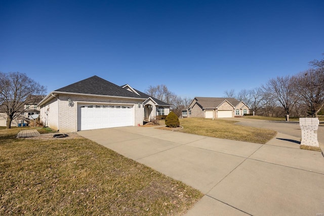 view of front facade featuring driveway, a garage, a shingled roof, brick siding, and a front yard