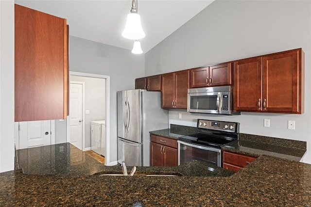 kitchen with sink, appliances with stainless steel finishes, hanging light fixtures, independent washer and dryer, and dark stone counters