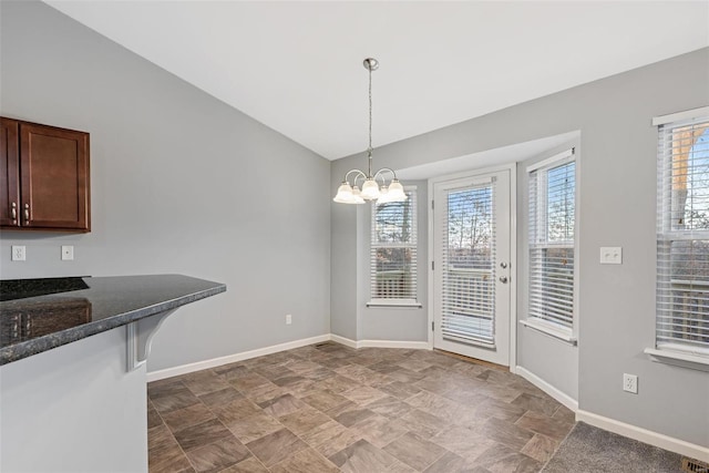 unfurnished dining area with an inviting chandelier