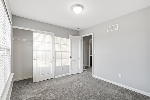 unfurnished bedroom with a closet and carpet