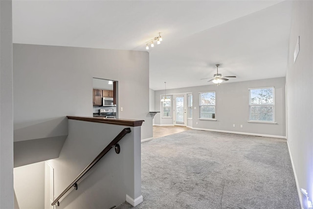 interior space featuring vaulted ceiling, ceiling fan, plenty of natural light, and carpet floors