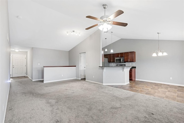 unfurnished living room featuring high vaulted ceiling, ceiling fan with notable chandelier, and light colored carpet