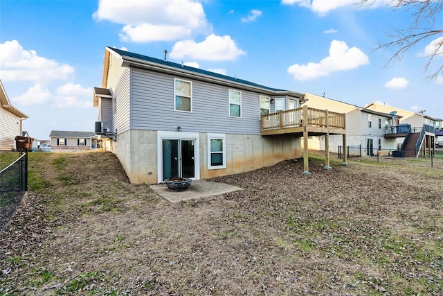 rear view of house with a wooden deck and central air condition unit