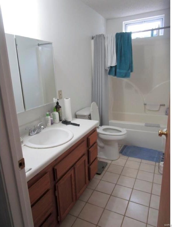 full bathroom with shower / tub combination, toilet, tile patterned floors, and vanity