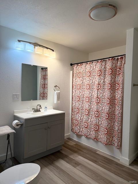 full bathroom featuring vanity, hardwood / wood-style floors, toilet, and shower / bath combo with shower curtain