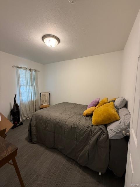 bedroom with carpet and a textured ceiling