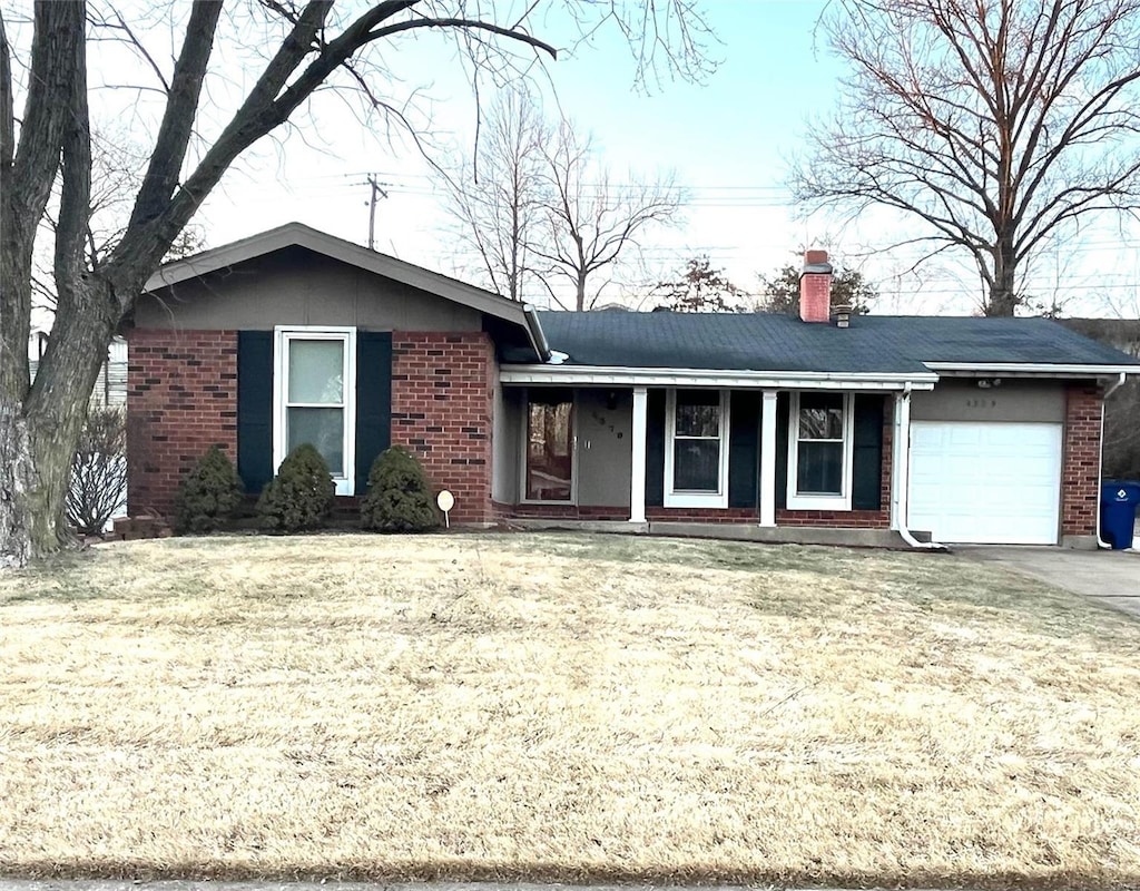 ranch-style house featuring a garage and a front lawn