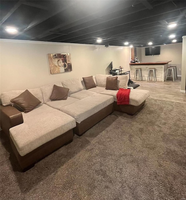 living room featuring wood-type flooring and bar