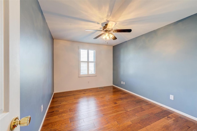 spare room featuring hardwood / wood-style flooring and ceiling fan