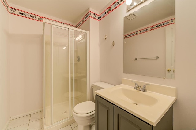 bathroom with vanity, tile patterned flooring, toilet, and walk in shower