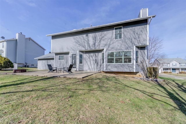 rear view of house with a patio and a lawn