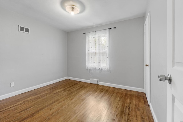 empty room featuring hardwood / wood-style flooring