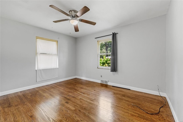 unfurnished room with hardwood / wood-style flooring and ceiling fan