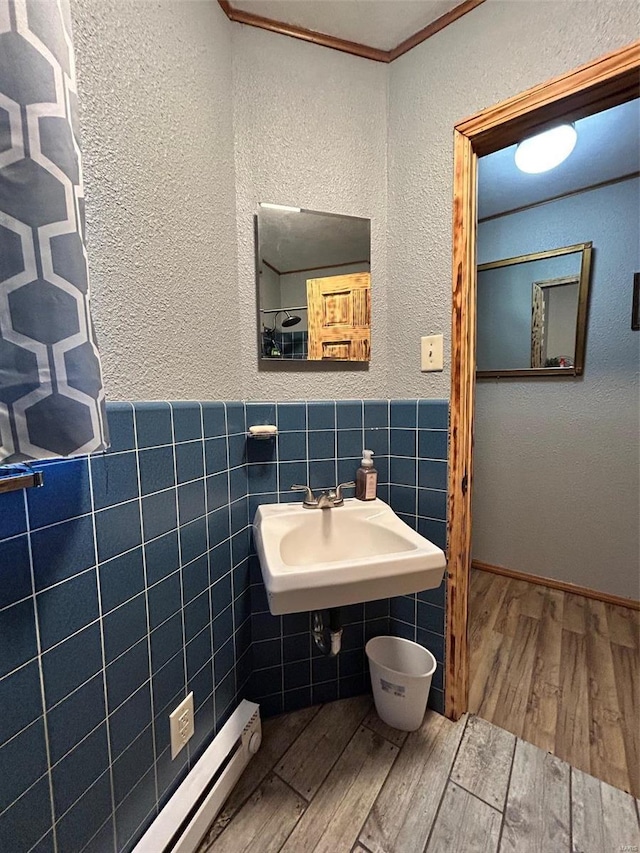 bathroom with tile walls, sink, and wood-type flooring