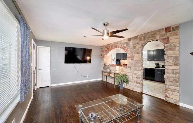 unfurnished living room with hardwood / wood-style flooring and ceiling fan