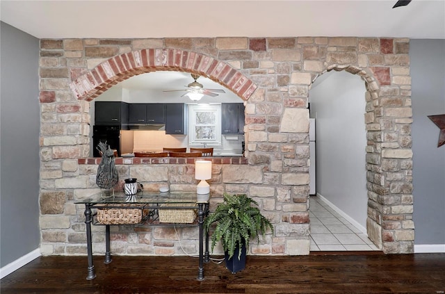 interior space with ceiling fan, refrigerator, oven, and hardwood / wood-style floors