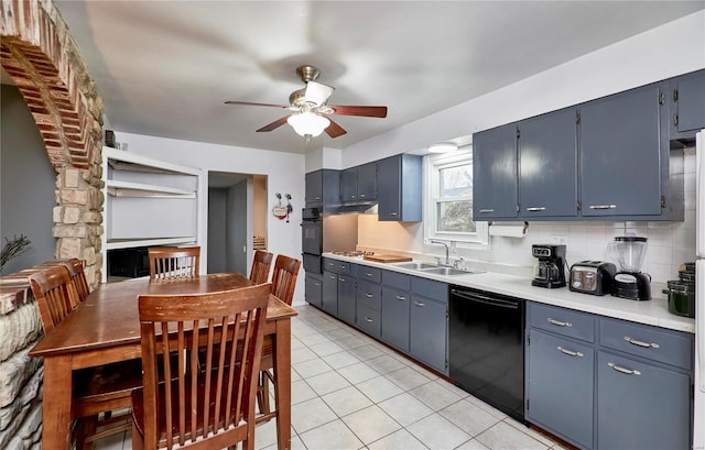 kitchen featuring sink, backsplash, black dishwasher, and blue cabinets