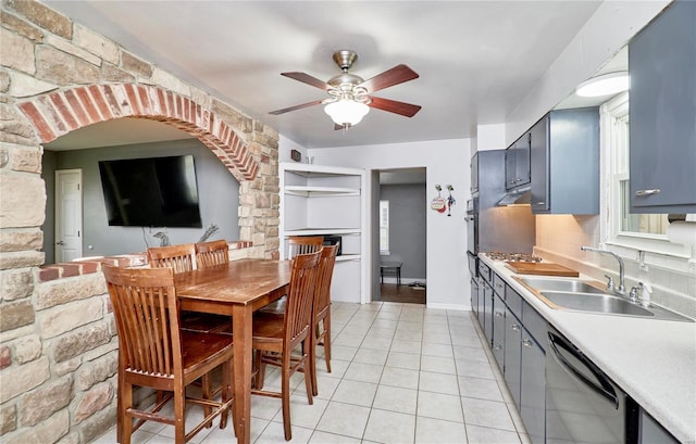 dining area featuring ceiling fan, sink, and light tile patterned floors