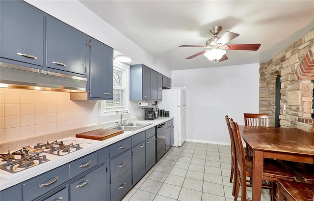 kitchen featuring tasteful backsplash, blue cabinetry, sink, and white appliances