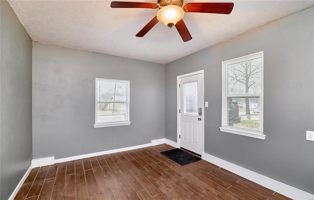 entrance foyer featuring dark hardwood / wood-style flooring, plenty of natural light, and ceiling fan