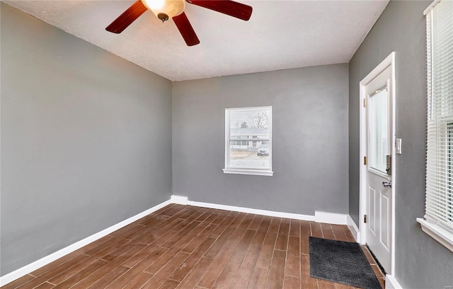 spare room with dark hardwood / wood-style floors and ceiling fan