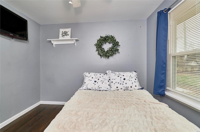 bedroom with dark wood-type flooring and ceiling fan