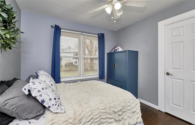 bedroom with dark wood-type flooring and ceiling fan