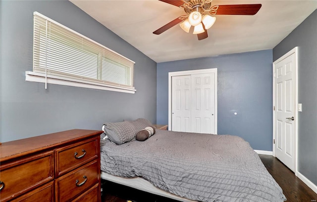 bedroom with dark wood-type flooring, a closet, and ceiling fan