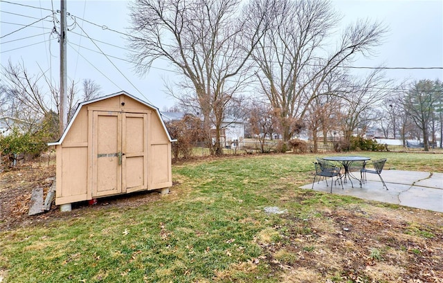 view of yard with a storage shed and a patio